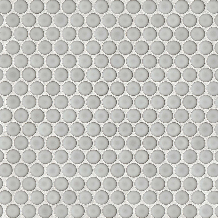 An overhead shot of the 360° Dove Grey penny round tile highlights its smooth, polished surface and soft grey shade, bringing a refined, modern touch to interiors.