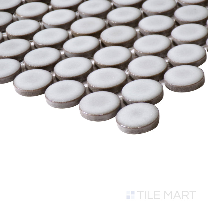Angled close-up of 360° Dove Grey 3/4" penny round gloss glazed porcelain mosaic, showcasing its soft grey tone, glossy texture, and the precise way its edges meet at the corner.