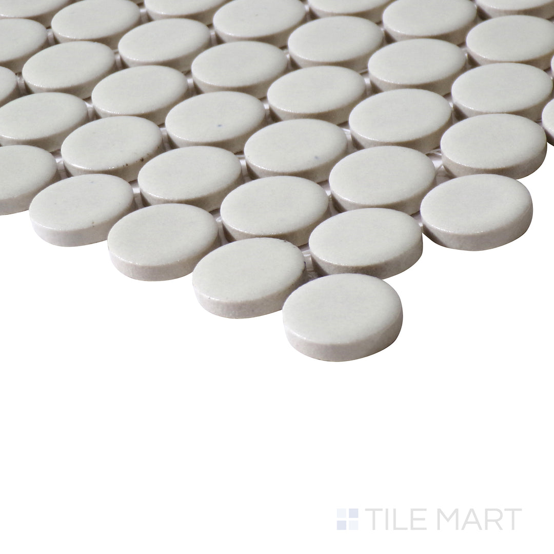 Side-angle perspective of 360° Off White 3/4" penny round gloss glazed porcelain mosaic, featuring a neutral off-white shade, radiant glossy finish, and smooth, curved edges aligning at a defined corner.