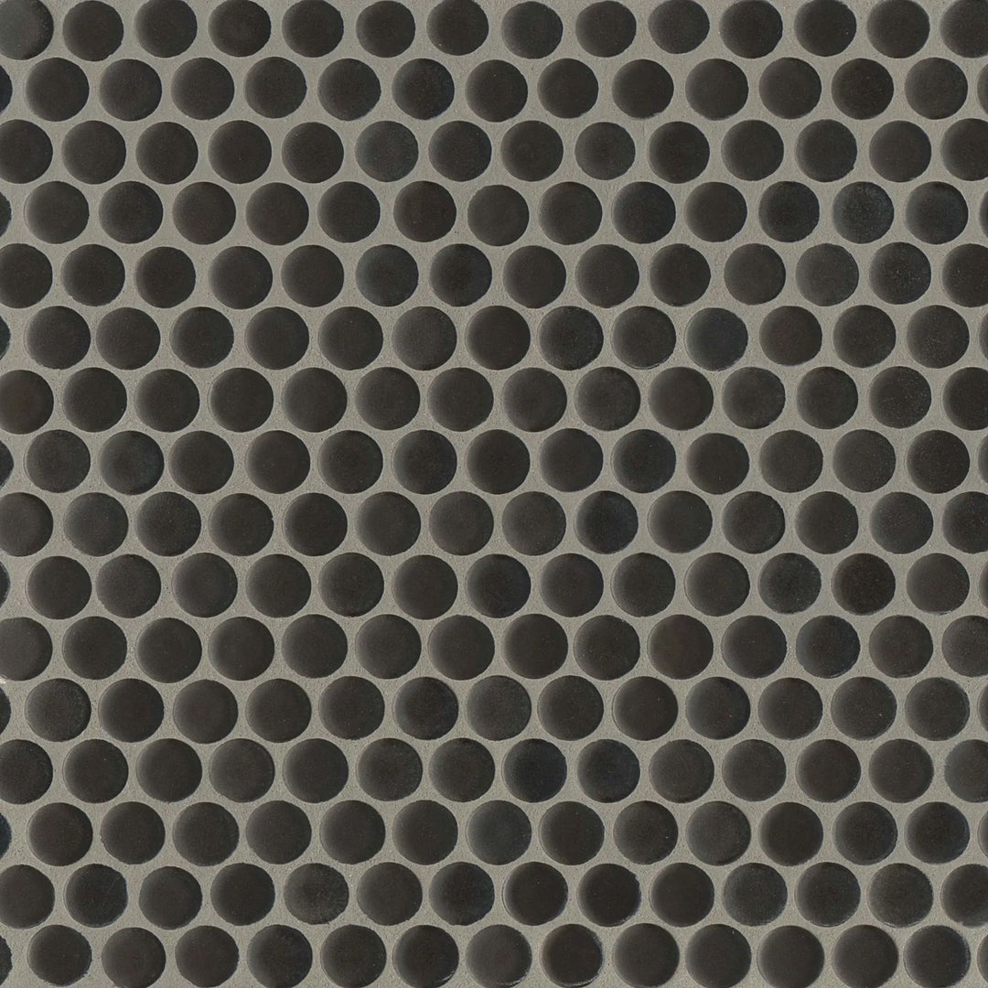 An overhead perspective highlights the 360° Charcoal penny round tile’s deep, dramatic tone and non-reflective matte glaze, adding a sleek modern edge.