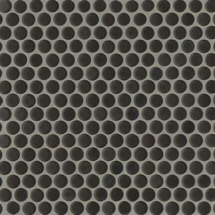 An overhead perspective highlights the 360° Charcoal penny round tile’s deep, dramatic tone and non-reflective matte glaze, adding a sleek modern edge.