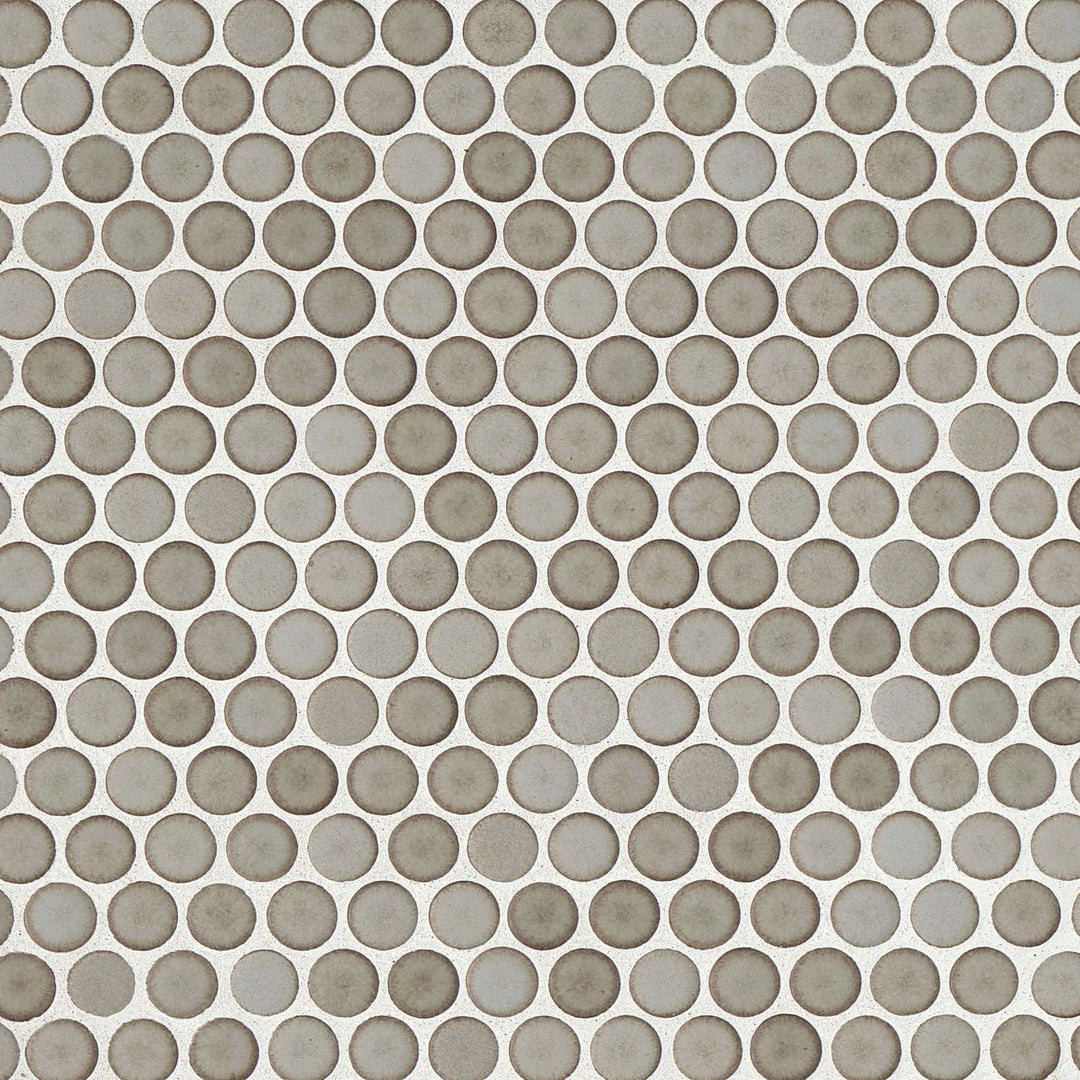 Looking straight down, the 360° Pumice penny round tile reveals a subtle balance between its soft stone-like color and smooth matte texture, making it a versatile design choice.