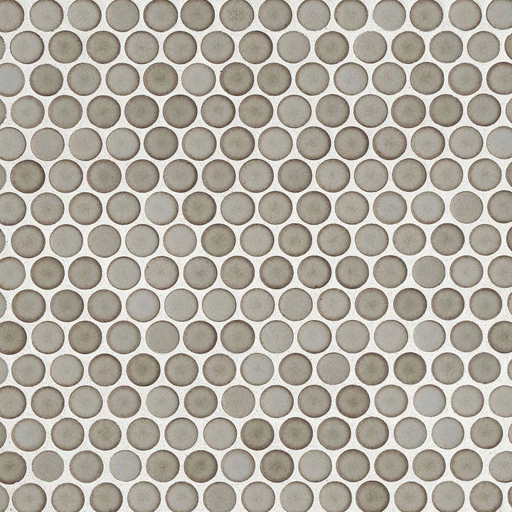 Looking straight down, the 360° Pumice penny round tile reveals a subtle balance between its soft stone-like color and smooth matte texture, making it a versatile design choice.
