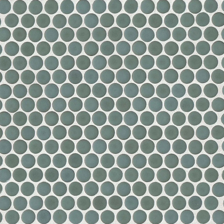 From an overhead angle, the 360° Silver Sage penny round tile showcases its delicate green-grey hue and velvety matte surface, perfect for creating a calming ambiance.