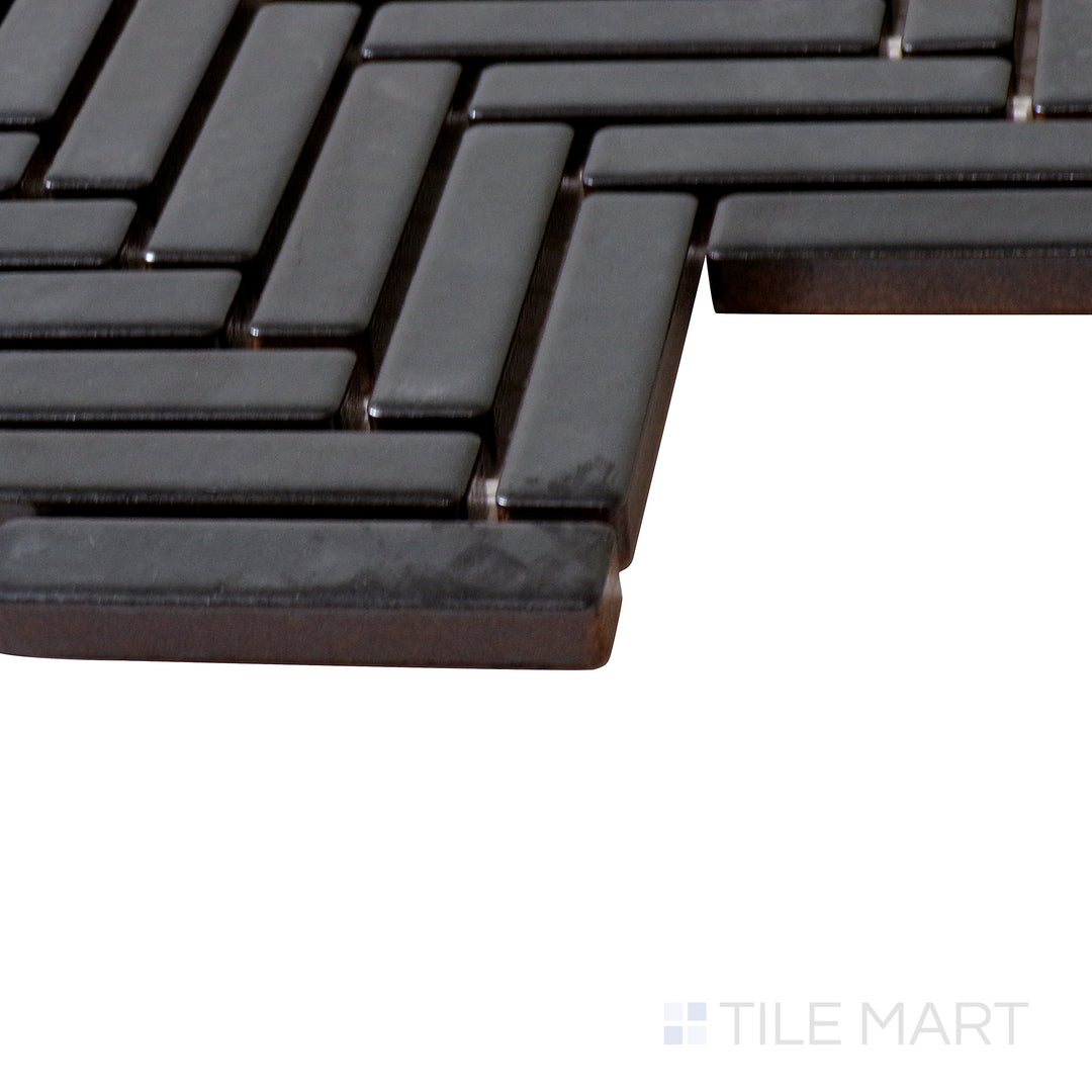 Angled close-up of 90° Metallic Herringbone gloss glazed porcelain mosaic, showcasing its subtle metallic sheen, structured herringbone design, and sharply defined intersections.