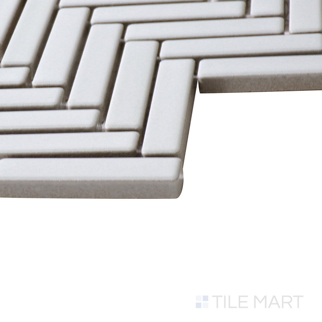 Corner shot of 90° White Herringbone gloss glazed porcelain mosaic, highlighting its bright white tone, sharp angles, and how the glossy finish enhances its structured layout.