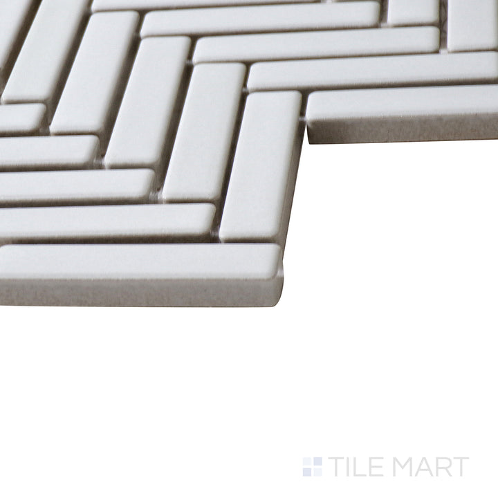 Corner shot of 90° White Herringbone gloss glazed porcelain mosaic, highlighting its bright white tone, sharp angles, and how the glossy finish enhances its structured layout.
