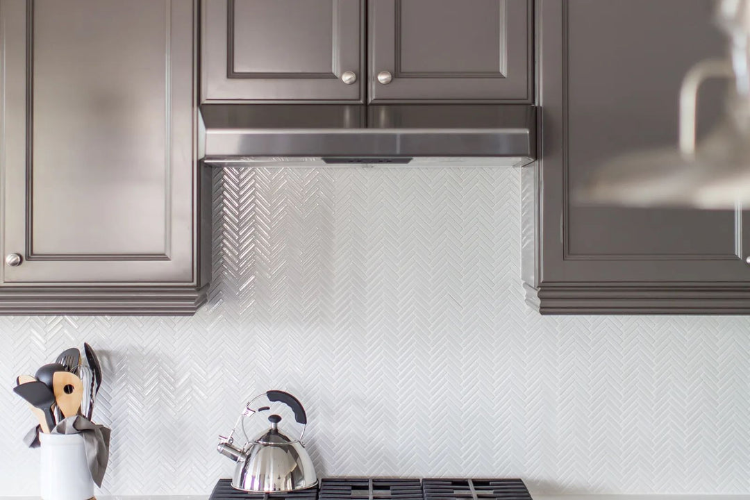 A herringbone pattern in glossy white porcelain adds dynamic movement and a modern touch, effortlessly styled with 90° White Herringbone gloss glazed porcelain mosaic.