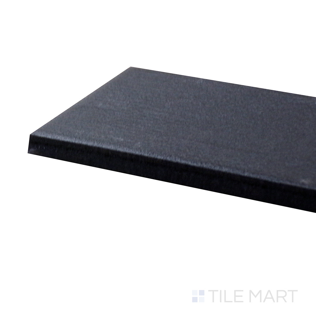 Side-angle close-up of Allora Black 3x24 matte glazed porcelain tile, showcasing its deep black shade, elongated form, and finely cut edges for a clean, structured look.