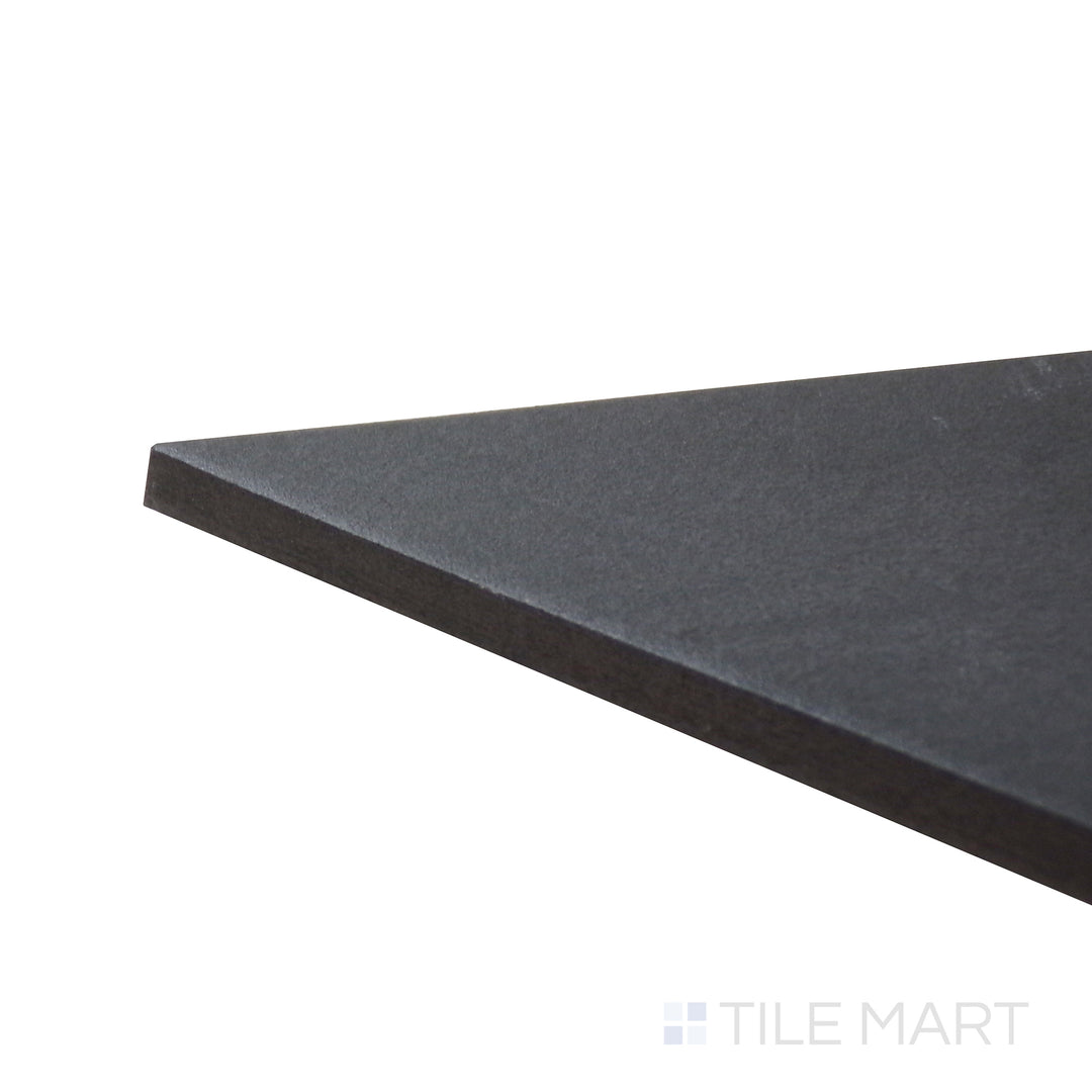 Angled close-up of Allora Black 7.375x12.75 matte glazed porcelain tile, emphasizing its bold black shade, elongated shape, and precisely aligned edge formation.