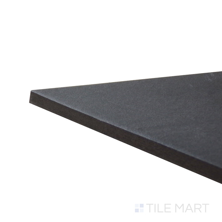 Angled close-up of Allora Black 7.375x12.75 matte glazed porcelain tile, emphasizing its bold black shade, elongated shape, and precisely aligned edge formation.