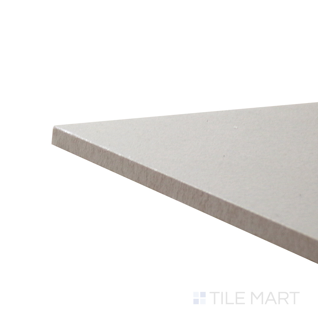 Corner shot of Allora Grey 7.375x12.75 matte glazed porcelain tile, featuring a muted grey hue, smooth texture, and the sharp intersection of its edges.