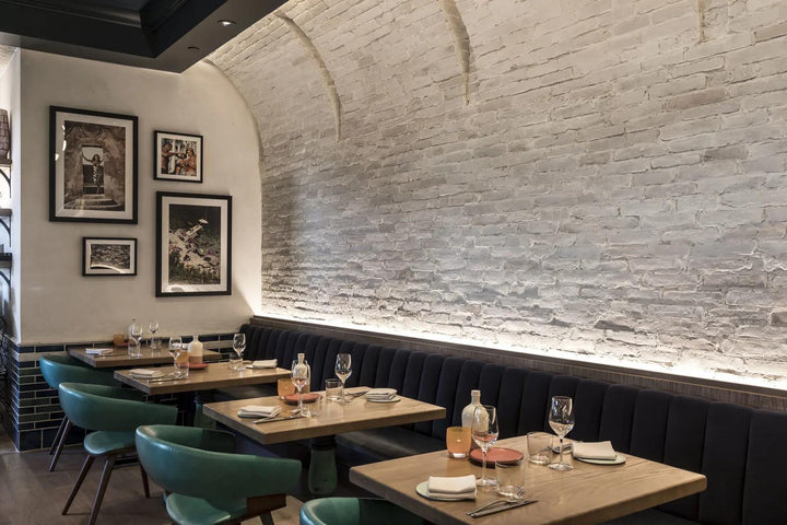 A rustic and industrial-inspired backdrop with Avondale Early Gray 2X8 Matte Brick, adding texture and an aged charm to the design.