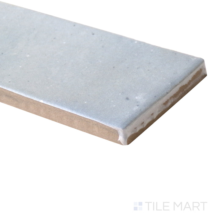 Angled close-up of Celine Blue 2x6 matte glazed porcelain tile, featuring a rich blue shade, smooth matte texture, and the seamless way its edges form a crisp corner.