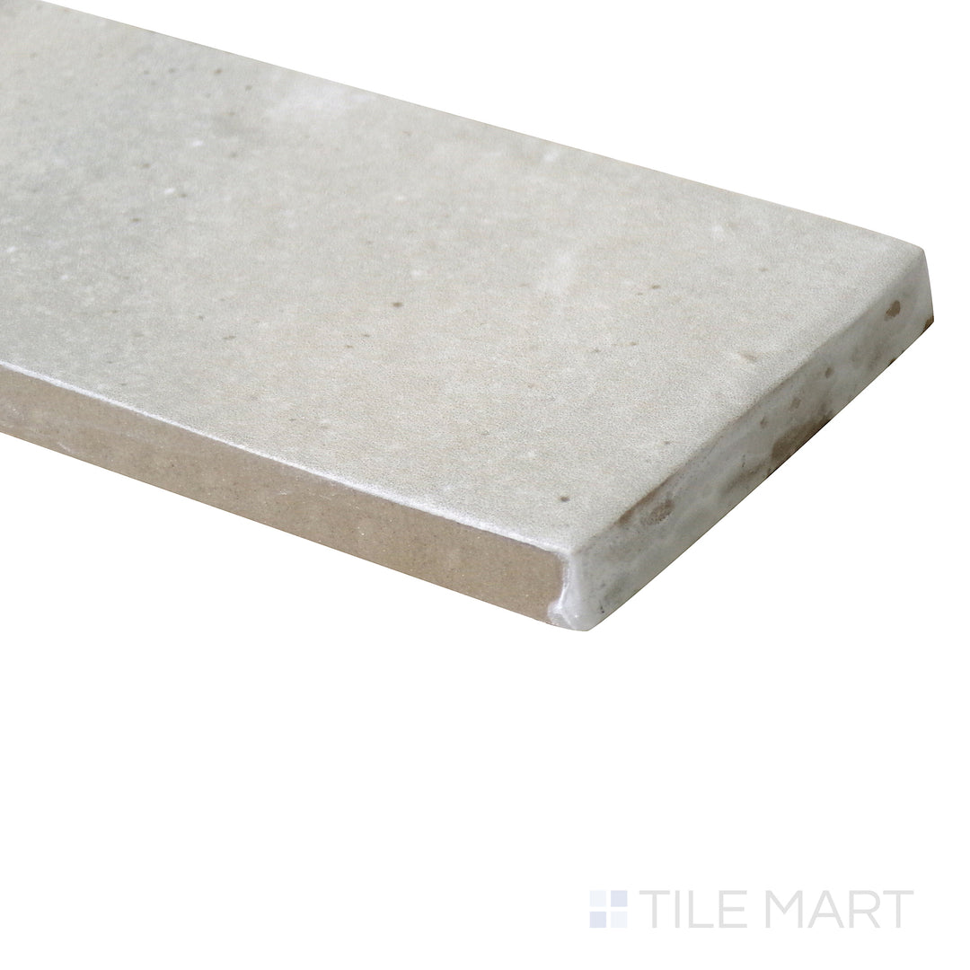 Corner-focused image of Celine Greige 2x6 matte glazed porcelain tile, displaying its neutral beige-grey color, velvety matte finish, and the way the edges meet at an exact angle.