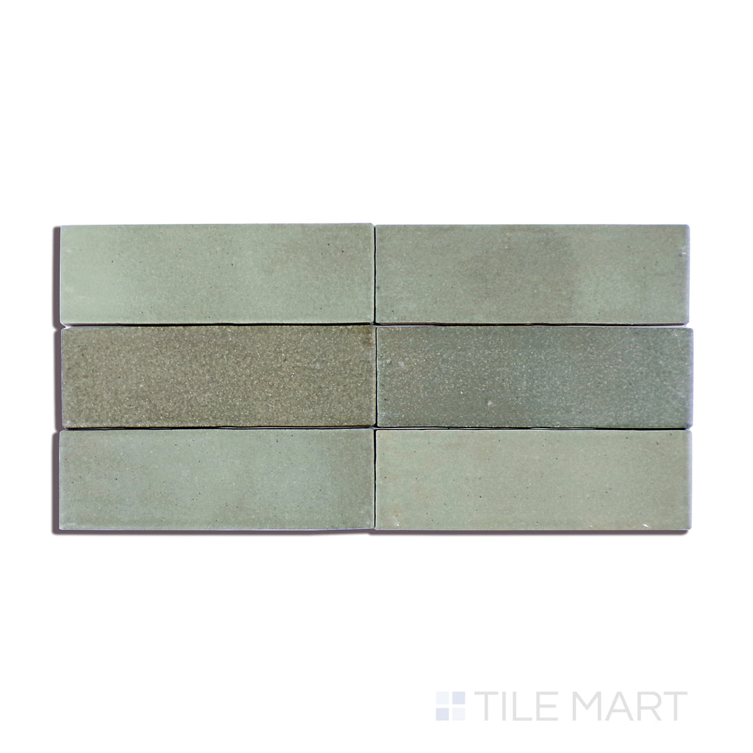 A detailed close-up of Celine Sage 2X6 Matte Glazed Porcelain tile captures its muted green tone and smooth matte texture, adding a refreshing natural touch.