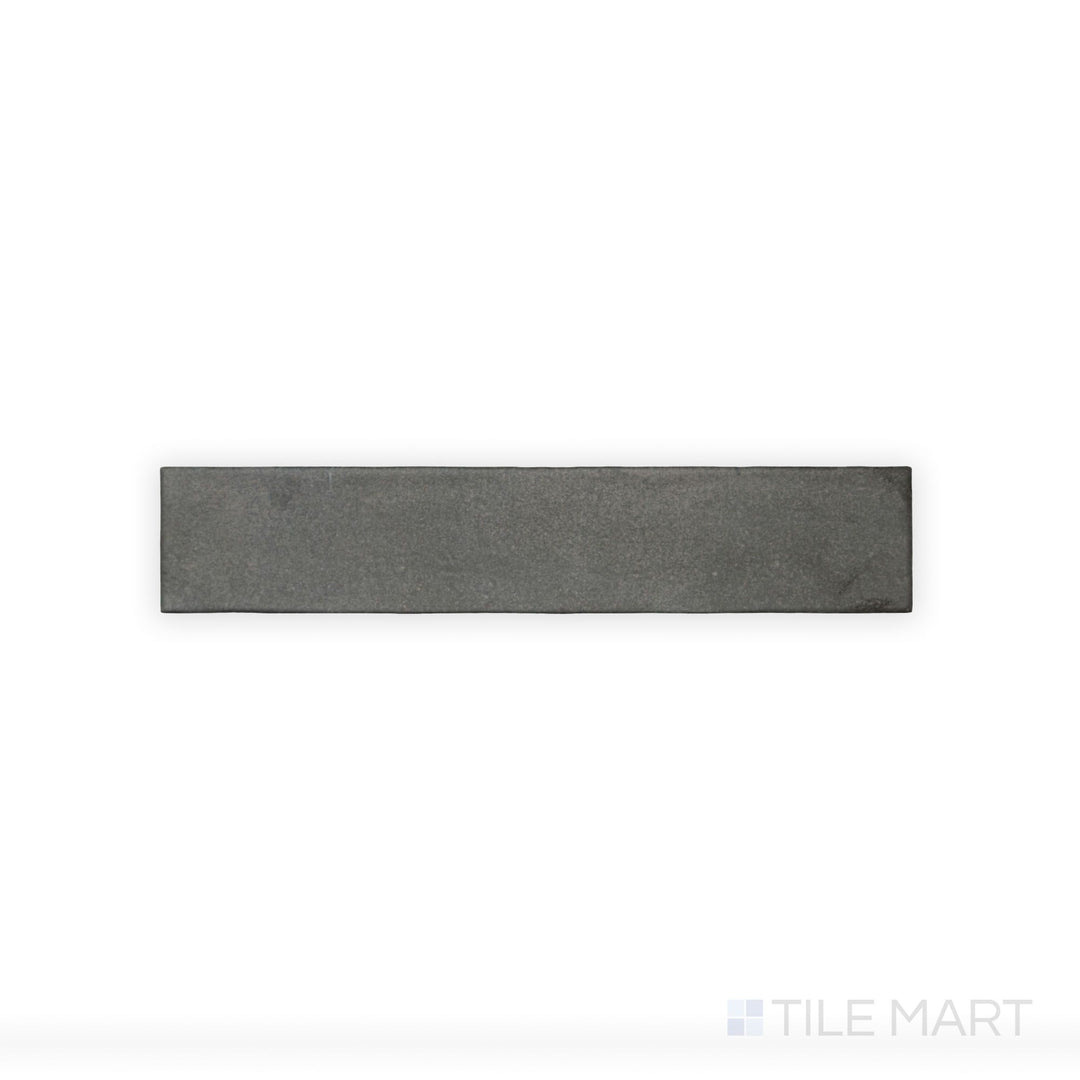 This close-up view of Celine Black 2.5X12 Matte Glazed Porcelain tile highlights its rich black color and understated matte glaze, ideal for creating bold contrasts.