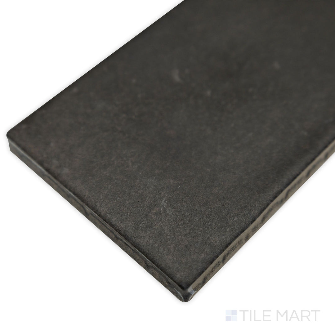 Corner shot of Celine Black 2.5x12 matte glazed porcelain tile, featuring its elongated shape, deep black color, and sharp-cut edges for a structured look.