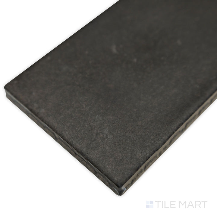 Corner shot of Celine Black 2.5x12 matte glazed porcelain tile, featuring its elongated shape, deep black color, and sharp-cut edges for a structured look.