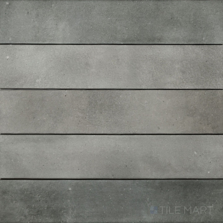 A top-down view of the Celine Greige 2.5x12 matte glazed porcelain tile reveals its balanced mix of gray and beige tones with a refined matte texture, perfect for subtle elegance.