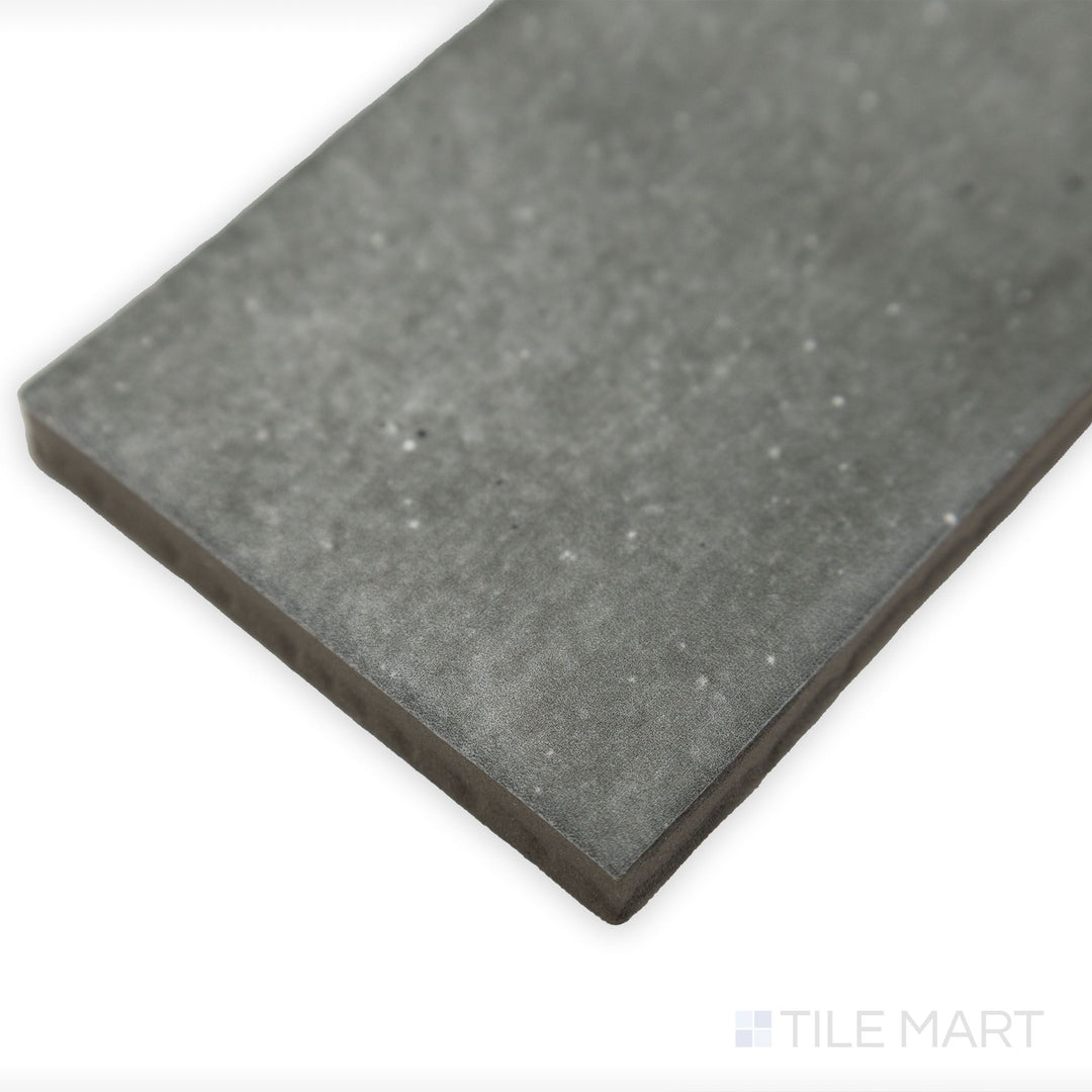 Side-angle close-up of Celine Greige 2.5x12 matte glazed porcelain tile, capturing its elegant neutral shade, uniform matte finish, and structured edge alignment.