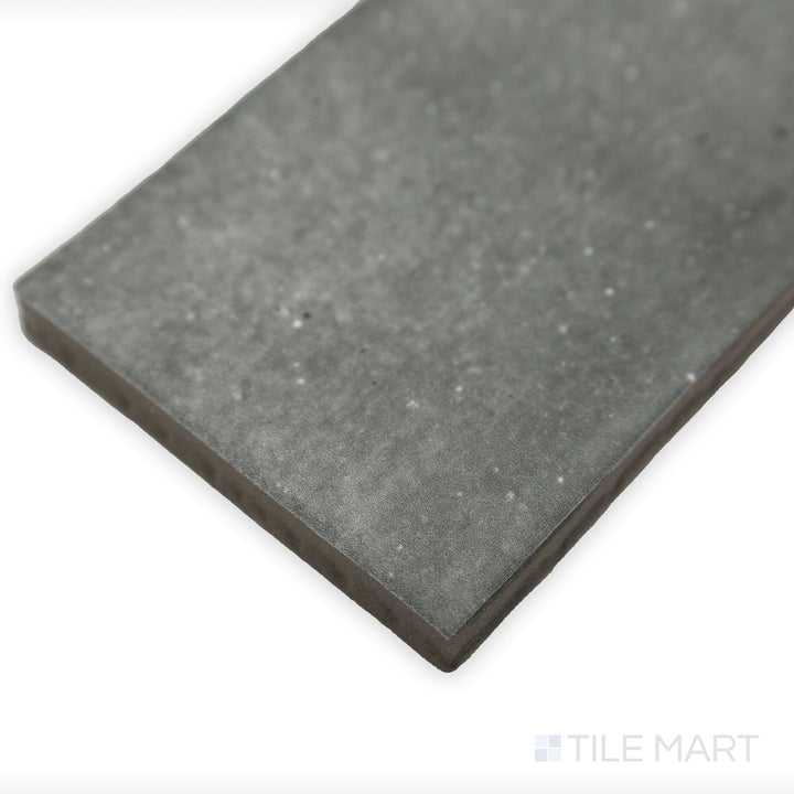 Side-angle close-up of Celine Greige 2.5x12 matte glazed porcelain tile, capturing its elegant neutral shade, uniform matte finish, and structured edge alignment.