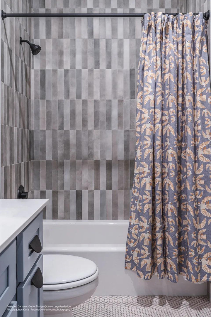 A balanced and warm greige tone with a matte texture, complemented by Celine Greige 2.5X12 Matte Glazed Porcelain.