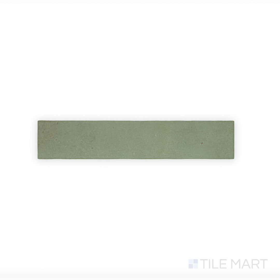 A macro view of Celine Sage 2.5X12 Matte Glazed Porcelain tile highlights its soft green hue and matte finish, adding a subtle, organic element to any space.