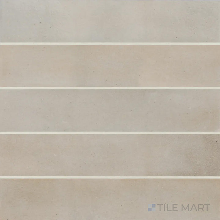 A top-down shot of the Celine Taupe 2.5x12 matte glazed porcelain tile highlights its earthy taupe shade with a smooth matte glaze, creating a warm and inviting aesthetic.