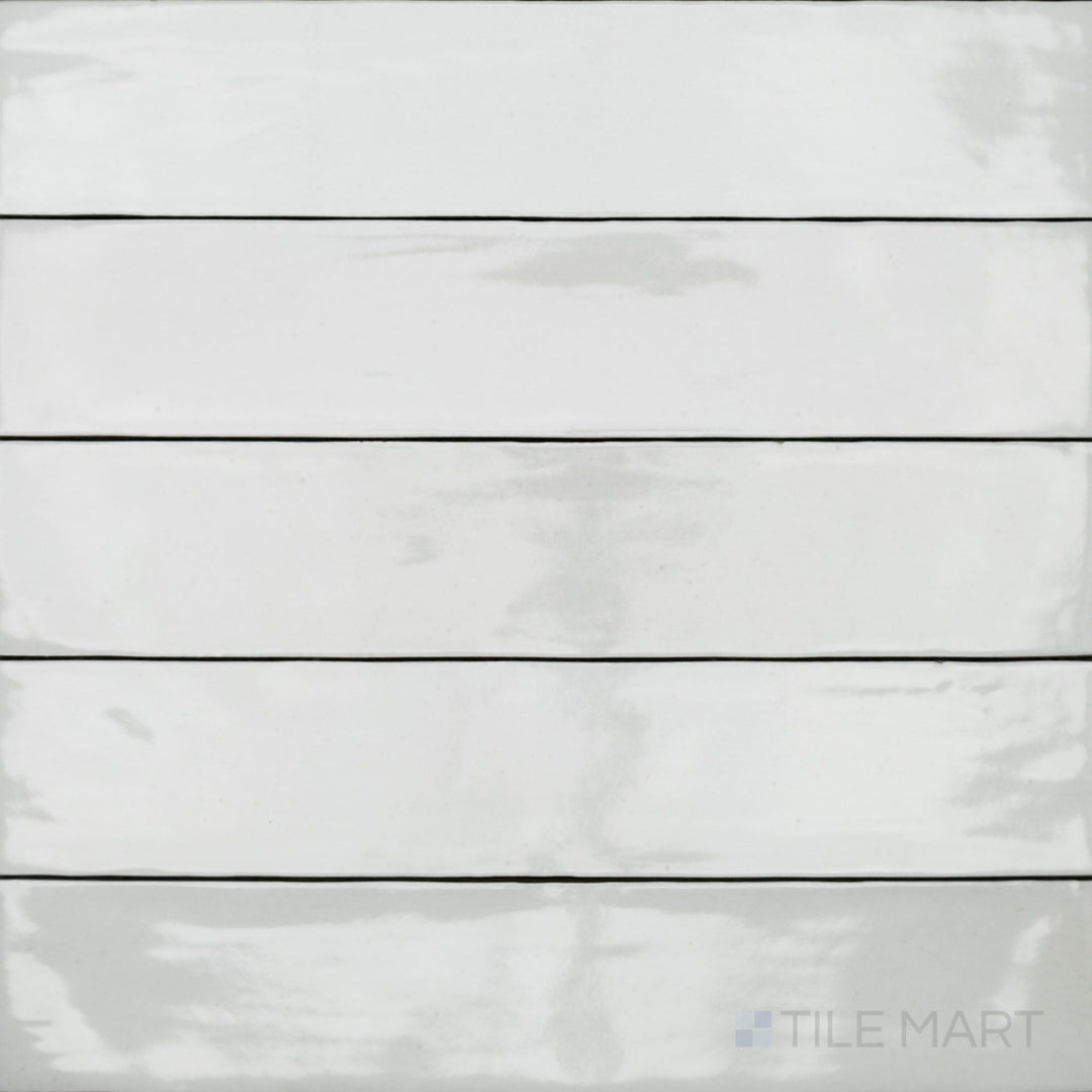 An overhead view of the Celine White 2.5x12 gloss glazed porcelain tile captures its crisp white color and reflective glossy surface, enhancing brightness and modern appeal.