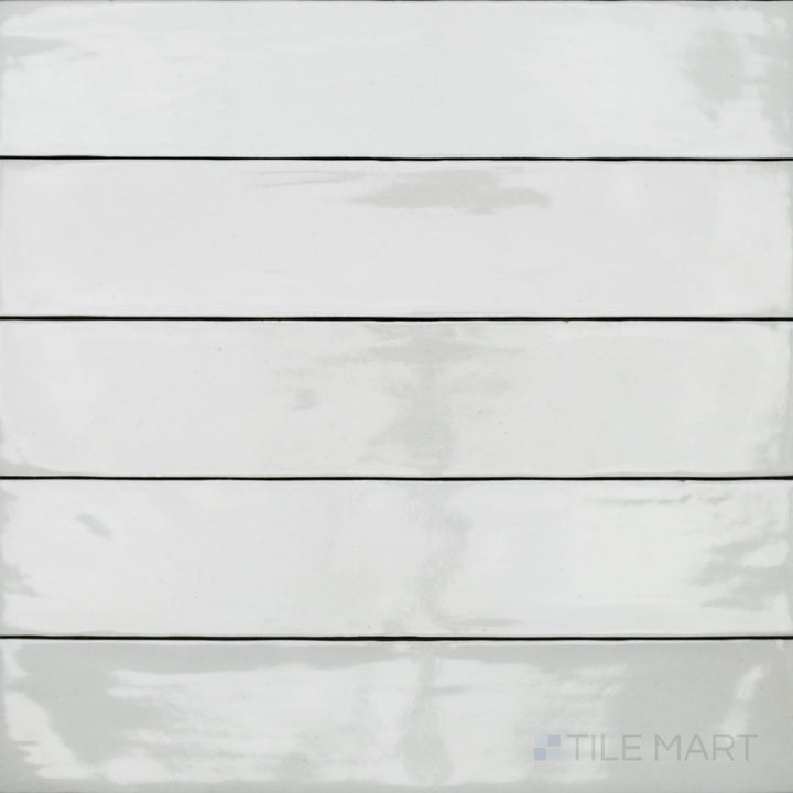 An overhead view of the Celine White 2.5x12 gloss glazed porcelain tile captures its crisp white color and reflective glossy surface, enhancing brightness and modern appeal.