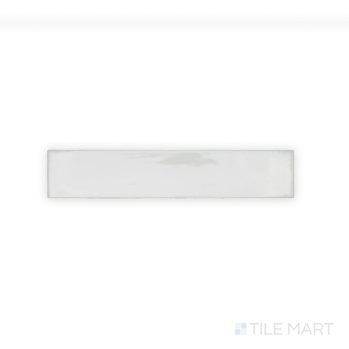 A finely detailed close-up of Celine White 2.5X12 Gloss Glazed Porcelain tile showcases its pristine white shade and high-gloss surface, adding a reflective and polished touch.