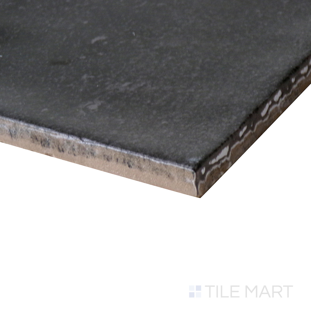 Corner shot of Celine Black 4x4 matte glazed porcelain tile, highlighting its bold black tone, finely cut edges, and the seamless way its matte surface diffuses light.