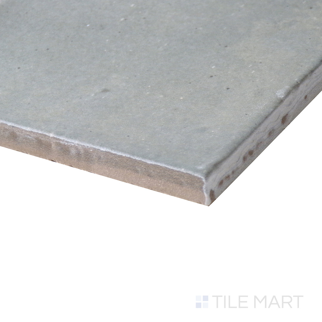 Angled close-up of Celine Blue 4x4 matte glazed porcelain tile, showcasing its vibrant blue shade, crisp matte finish, and the structured corner formation where edges meet.