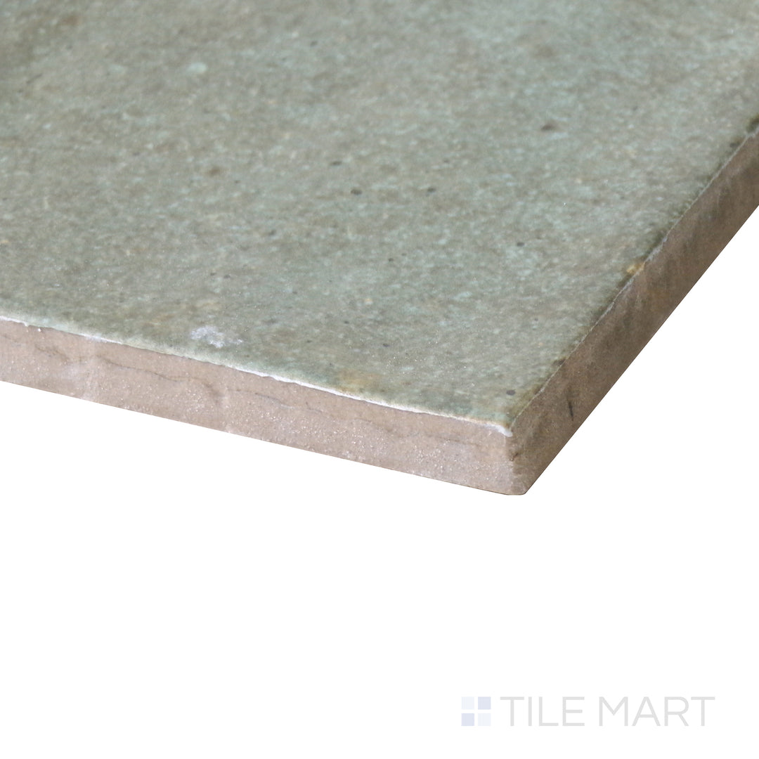 Side-angle close-up of Celine Sage 4x4 matte glazed porcelain tile, featuring its soft green undertone, finely crafted edges, and velvety matte finish.