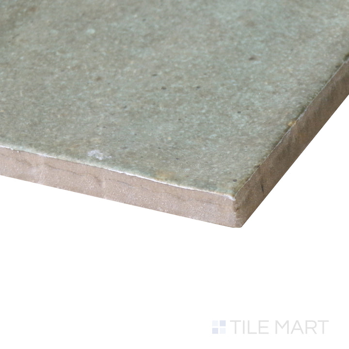Side-angle close-up of Celine Sage 4x4 matte glazed porcelain tile, featuring its soft green undertone, finely crafted edges, and velvety matte finish.