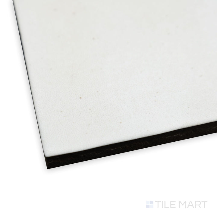 Angled close-up of Celine White 4x4 matte glazed porcelain tile, showcasing its bright white tone, fine matte surface, and precisely aligned corners creating a clean intersection.