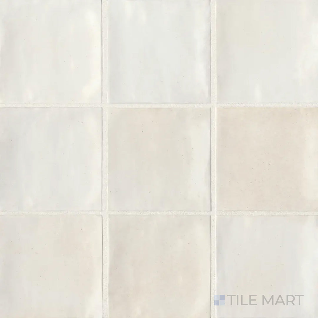 An overhead perspective of the Celine White 4x4 gloss glazed porcelain tile showcases its bright white color with a reflective glossy finish, enhancing light and space.