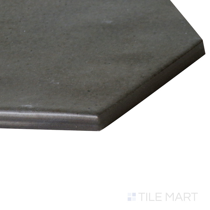 Corner shot of Celine Black 4" hex matte glazed porcelain tile, highlighting its deep black color, geometric hexagonal pattern, and soft matte finish meeting at a seamless junction.