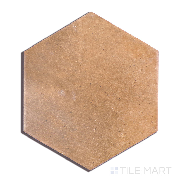 This close-up shot of Celine Cotto 4" Hex Matte Glazed Porcelain tile showcases its warm, rustic tone and smooth matte glaze, adding texture and character to any space.