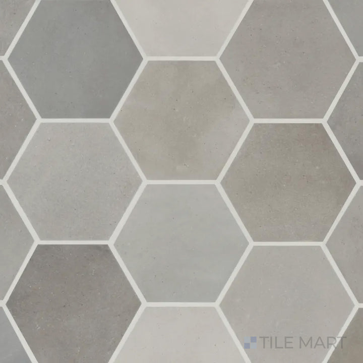 A top-down perspective of the Celine Greige 4" hex matte glazed porcelain tile highlights its blend of gray and beige tones with a sophisticated matte texture in a geometric shape.