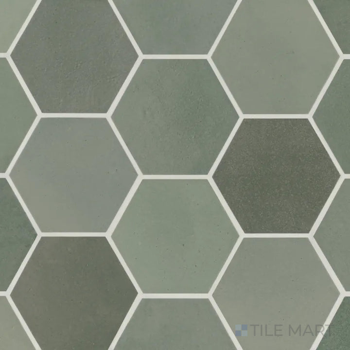 An aerial shot of the Celine Sage 4" hex matte glazed porcelain tile displays its soft green hue with a smooth matte surface, adding a natural touch to contemporary designs.