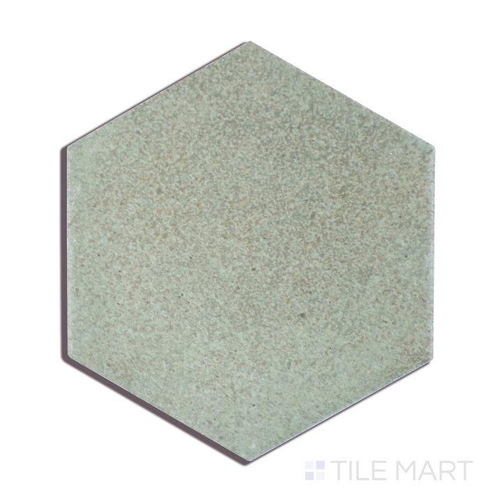 A close-up perspective of Celine Sage 4" Hex Matte Glazed Porcelain tile reveals its soft green shade and subtle matte glaze, creating a natural and calming effect.
