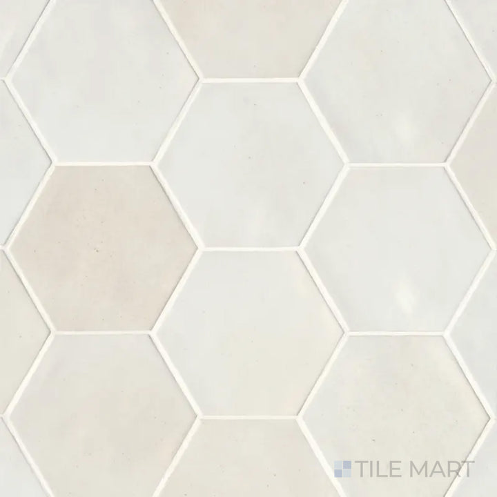 A top-down shot of the Celine White 4" hex gloss glazed porcelain tile highlights its crisp white tone and reflective surface, ideal for bright and airy interiors.