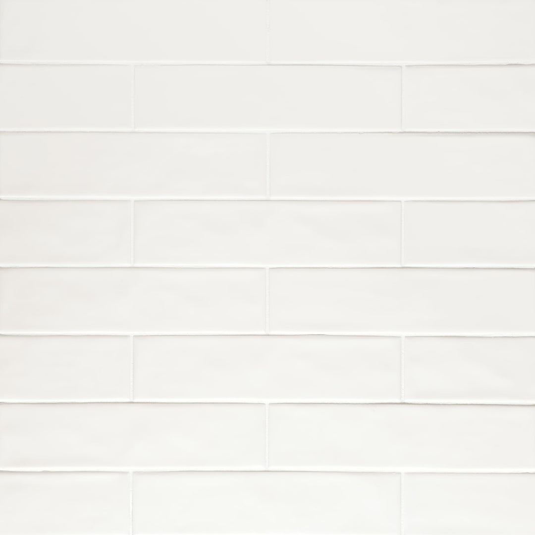 From an overhead view, the Clara White 2.75X11 matte glazed porcelain tile displays a soft, powdery texture, with a uniform white hue that enhances its understated elegance.