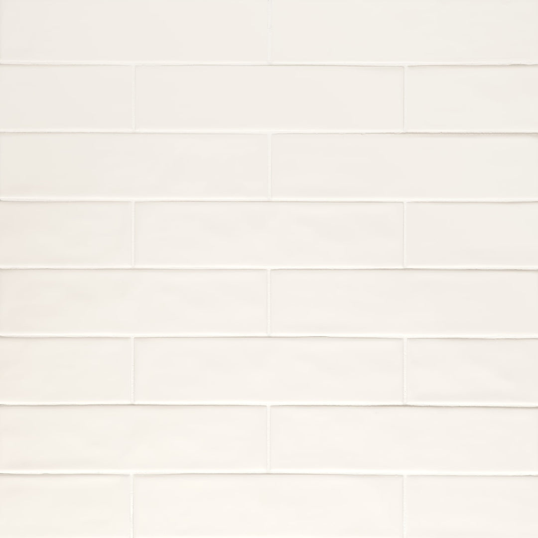 Viewed from above, the Clara Ivory 2.75X11 matte porcelain tile presents a warm, neutral tone with a smooth, velvety finish, adding subtle depth to the surface.