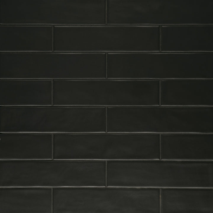 Seen from the top, the Clara Noir 2.75X11 matte porcelain tile reveals its deep black tone and muted surface, offering a bold yet smooth aesthetic with minimal glare.