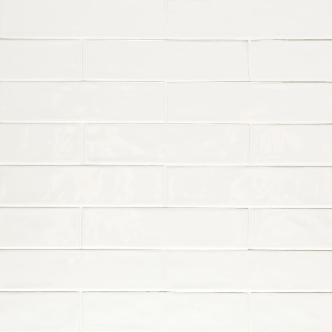 A bird’s-eye view of the Clara White 2.75X11 glossy porcelain tile captures its pristine white color and high-shine surface, reflecting light beautifully to brighten any space.