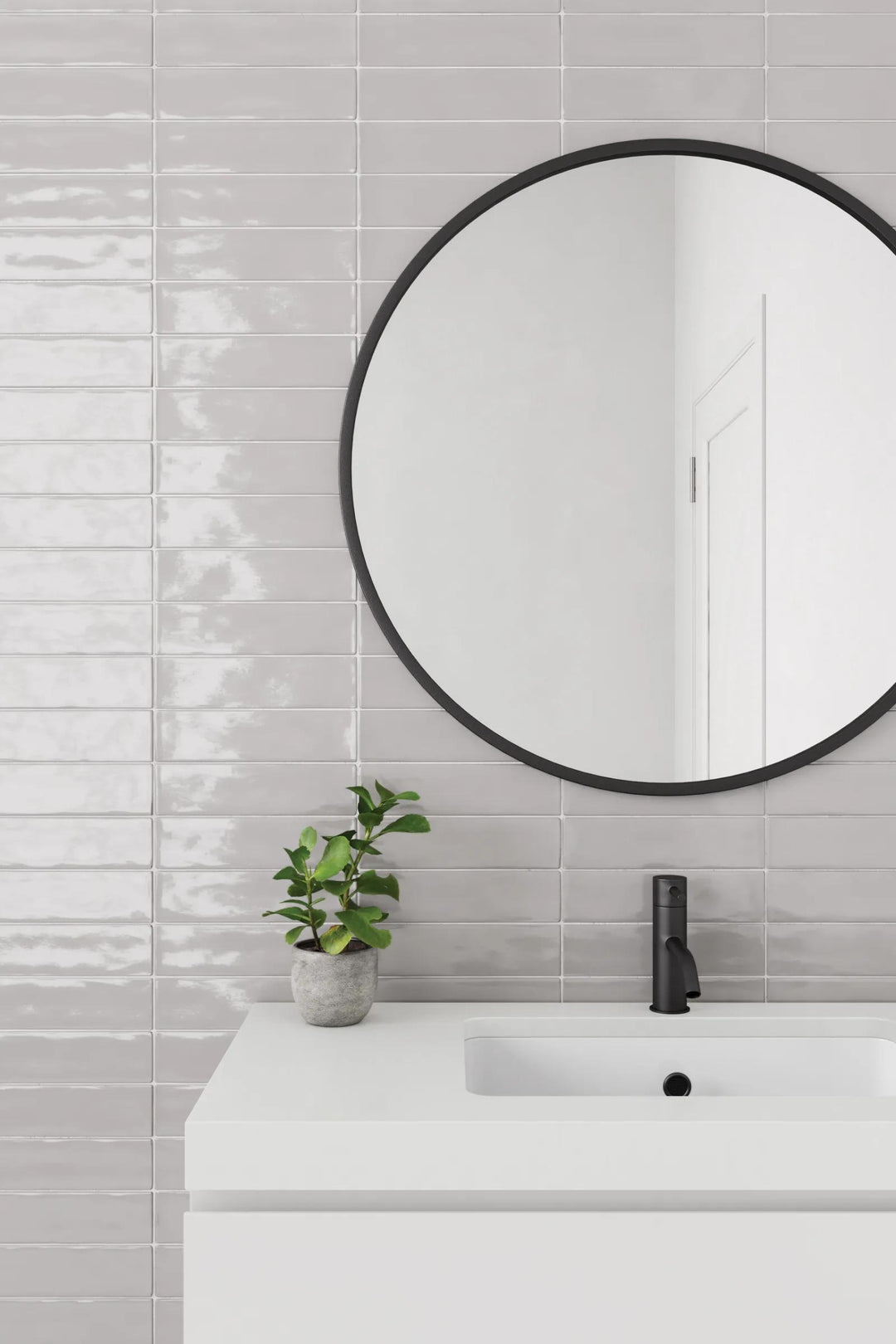 A refined grey surface with a glossy finish that enhances depth and texture, highlighted by Clara Grey 2.75X11 Glossy Glazed Porcelain.