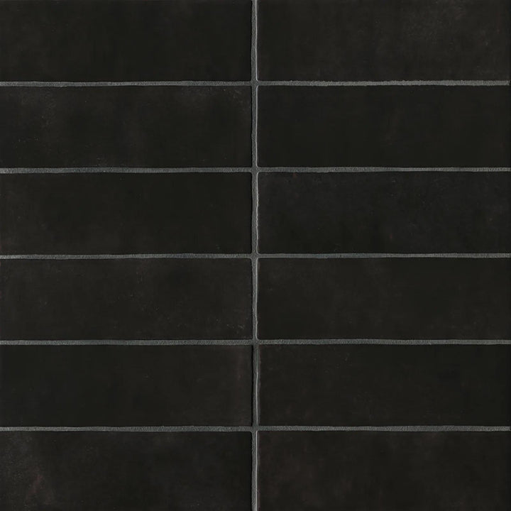 A top-down shot of the Cloe Black 2.5X8 glossy ceramic tile showcases its deep ebony tone and high-gloss finish, reflecting light beautifully for a modern aesthetic.